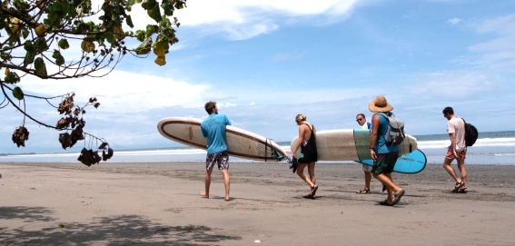 four student sand instructor walking to the waves at Playa Grande