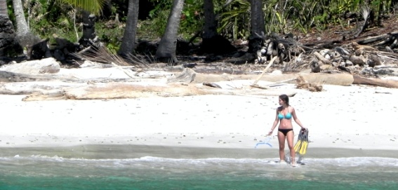 woman with snorkel gear on beach