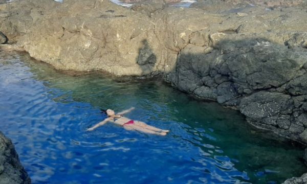 woman floating in the Amor De Mar Tide Pool