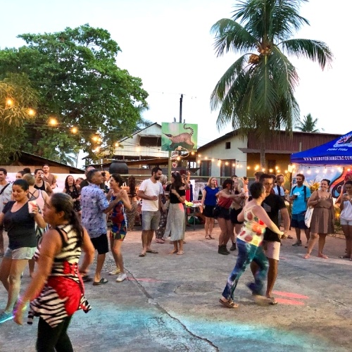 People Dancing in scarlet macaw flying in Montezuma Costa Rica