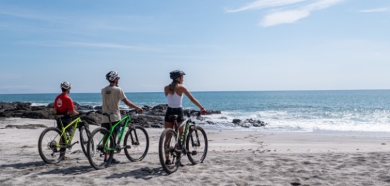 three mountain bikers looking at playa manchas