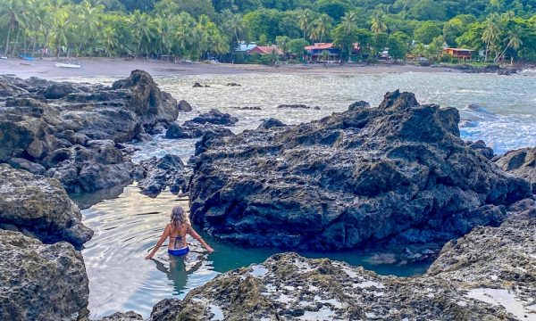 Woman wading in the Pico tide pool, Montezuma Costa Rica