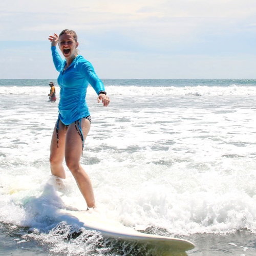 Montezuma Costa Rica woman smiling catching a wave
