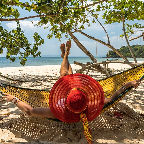 woman in red hat relaxing in Montezuma Costa Rica in hammock