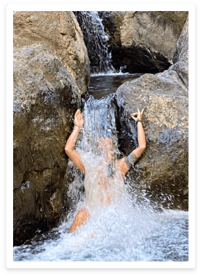 woman under small waterfall